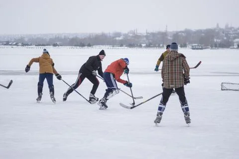 Group of active different age and sex people playing hokey Stock Photos