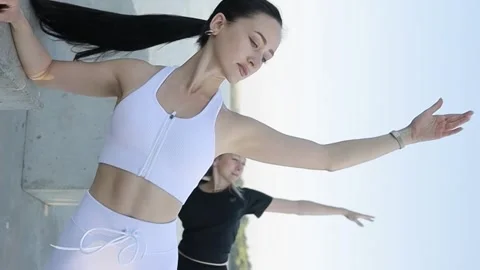 Group of active girls doing stretching exercises, slow motion camera. Vertical Stock Footage 250126533
