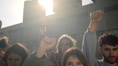 Group of activist people standing looking at camera with fist in the air during Stock Footage 162641279