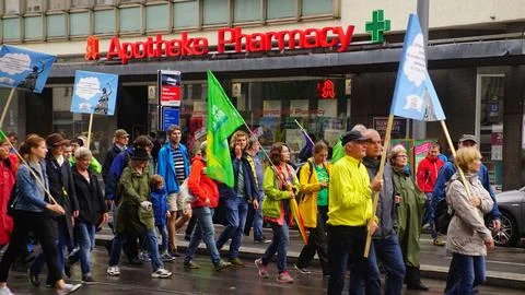 Group of activists marching with flags and banners, protesting for climate .. Foto stock