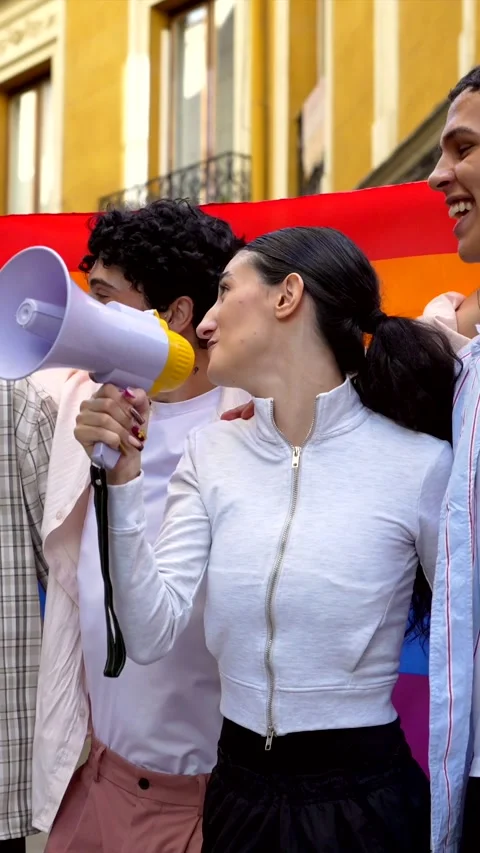Group of activists shouting slogans during pride parade Stock Footage 318828378