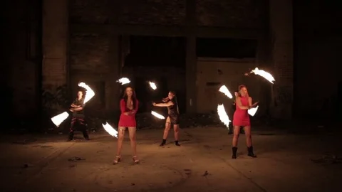Group of actors shows fire show in an old aircraft hangar. Stock Footage 79676172