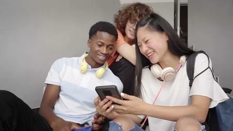 Group of adolescent students of different ethnicities using cell phones. Chinese Stock Footage 163076524