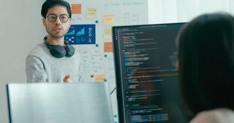Group adult Asia software developers mentor leader manager talk prompt AI. Stock Footage 312194570