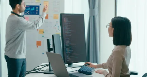 Group adult Asia software developers mentor leader manager talk prompt AI. Stock Footage 312194682