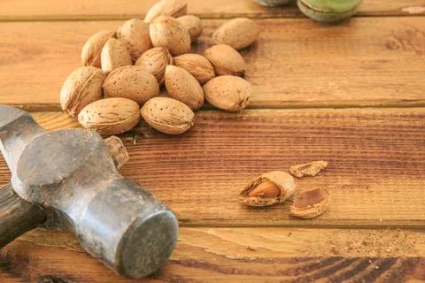 Group of almonds with hammer Stock Photos