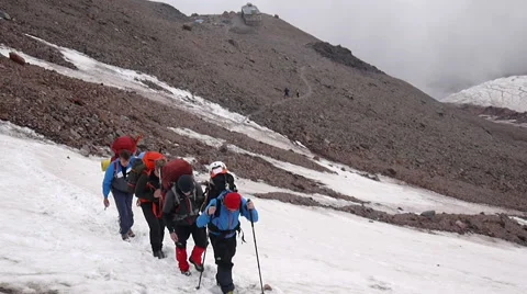 Group of Alpine Climbers ascending through snow in Mountains Stock Footage 43248915