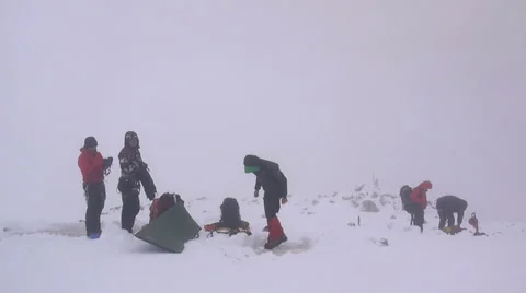 Group of alpine climbers getting ready to leave the camp Stock Footage 43249194