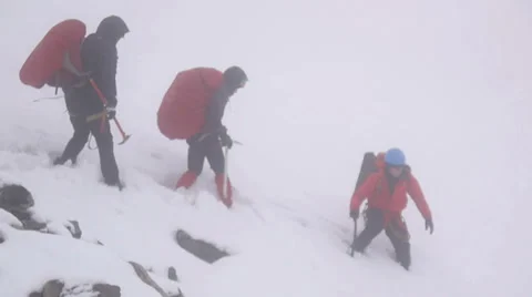Group of Alpine Climbers walking through avalanche area Stock Footage 43248788