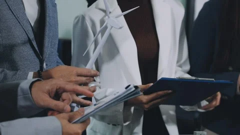 Group of alternative energy engineers discussing a project with a worker du.. Stock Footage 334138216