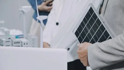 Group of alternative energy engineers discussing a project with a worker du.. Stock Footage 334138295