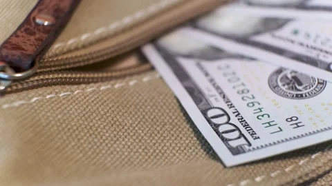 Group of American Banknotes of 100 Dollars in a canvas bag pocket Stock Footage 139534221