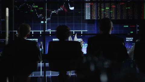 A group of analysts is watching the graphs and scales on the screens. HD Stock Footage 192577766