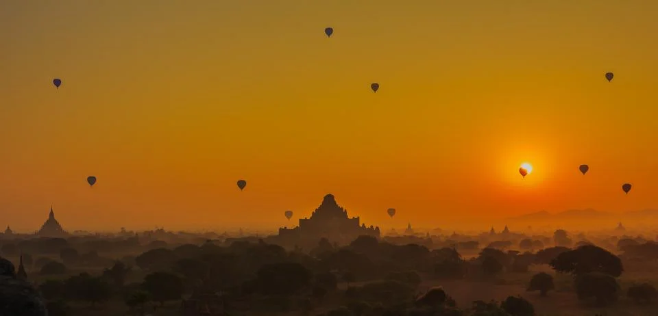 Group of ancient pagodas in Bagan with altitude balloons at the sunrise, baga Stock Photos