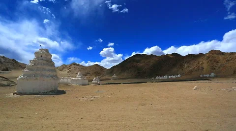 A group of ancient stupas in the background of the cloudy sky and mountains Stock Footage 41751077