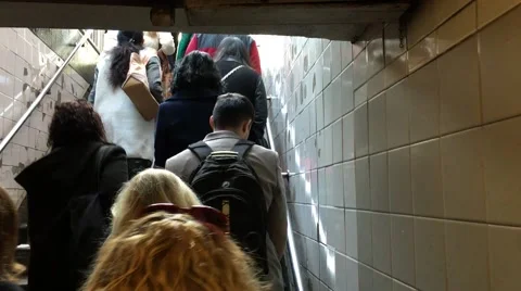A group of anonymous commuters walking up subway stairs in NYC Stock Footage 61626870