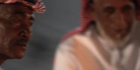 A group of Arabic men having a conversation, around a camp fire. Video stock 46870853