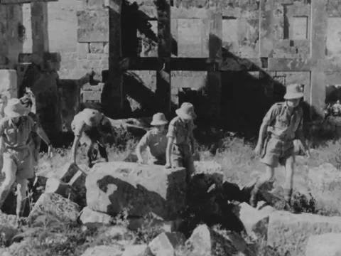 Group of archaeologists walking among Middle Eastern ruins Stock Footage 158024533