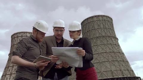 Group of architects and designers on background of the nuclear power plant. the Stock Footage 75357652