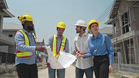 Group of architects and engineers work together to assess the residential home Video stock 308912420