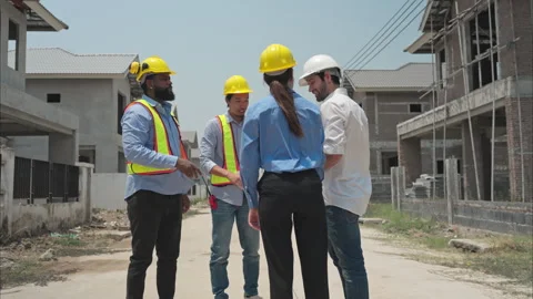 Group of architects and engineers work together to assess the residential home Stock Footage 308912625