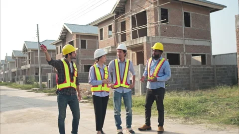 Group of architects and engineers work together to assess the residential Stock Footage 308929831