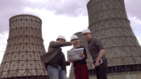 Group of architects discussing a construction plan on the background of Cooling Stock Footage 75357166