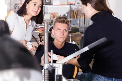 Group of architects discussing elements of architectural model 스톡 사진