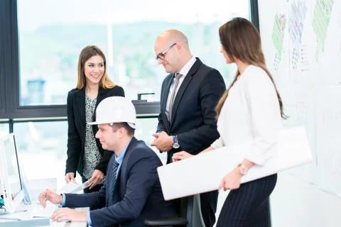 Group Of Architects Having Meeting. Solving problems and making strategy on c Stock Photos