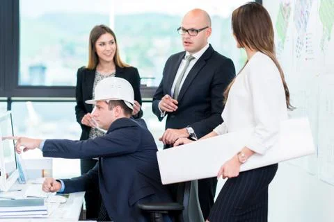 Group Of Architects Having Meeting. Solving problems and making strategy on c Stock Photos