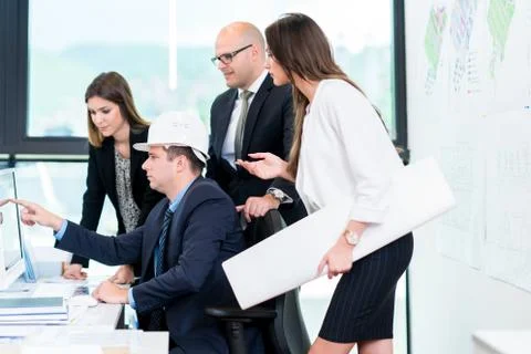 Group Of Architects Having Meeting. Solving problems and making strategy on c Stock Photos