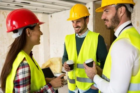 Group of architects talking on coffee break at construction site Stock Photos