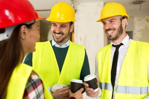 Group of architects talking on coffee break at construction site Stock Photos
