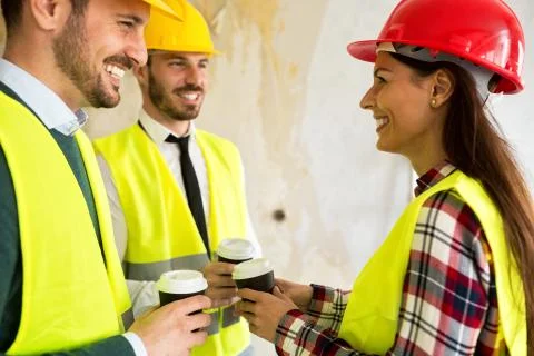 Group of architects talking on coffee break at construction site Stock Photos
