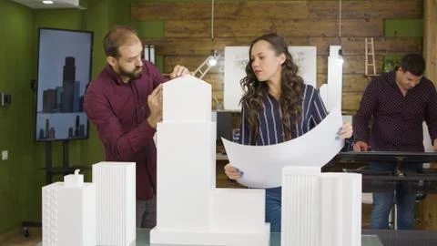 Group of architects working on 3D printed models of buildings Fotos de archivo