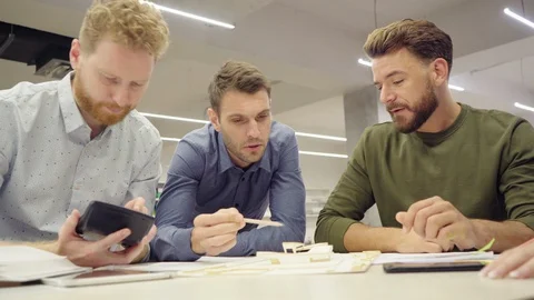 Group of architects working together on blueprint Stock Footage 128838059