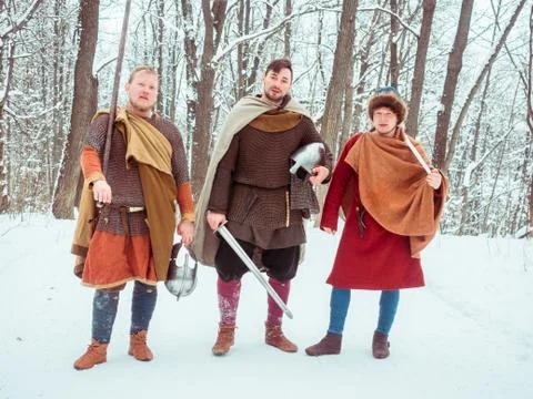 Group of armed medieval warriors with shields, swords, spears in the winter Stock Photos