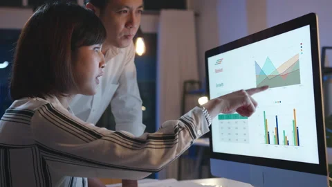 Group of Asia businesspeople using computer presentation in night home office. Stock Footage 144074012