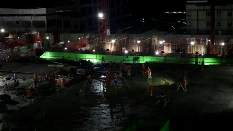 Group Asian Construction workers build building or factory during night Stock Footage 143966511