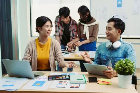 Group of asian creative team programing designers participate in all phases of Stock Photos