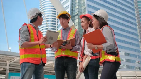 Group of Asian engineer man and woman workers work and discuss together in city Stock-Footage 143449069