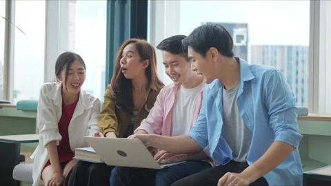 A group of Asian high school students meets in an office boardroom to use laptop Video stock 166500488