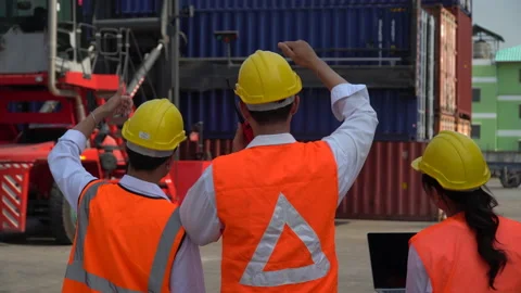 Group of asian young foreman talking on the walkie-talkie control loading Con Stock Footage 159393168