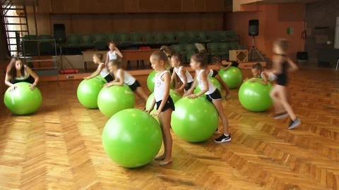 A group of athletes performs an exercise on fitballs 스톡 동영상 115320069