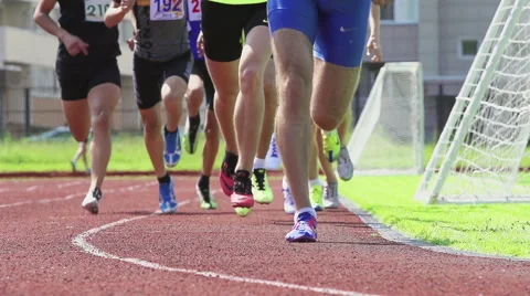 A group of athletes run on a stadium track - slow motion Vídeo Stock 64841606