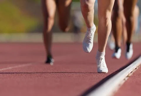 Group of athletes sprinters run speed on track Stock Photos