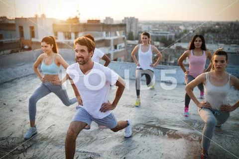 Group of athletic young people, friends in sportswear doing exercises. Sport Stock Photos