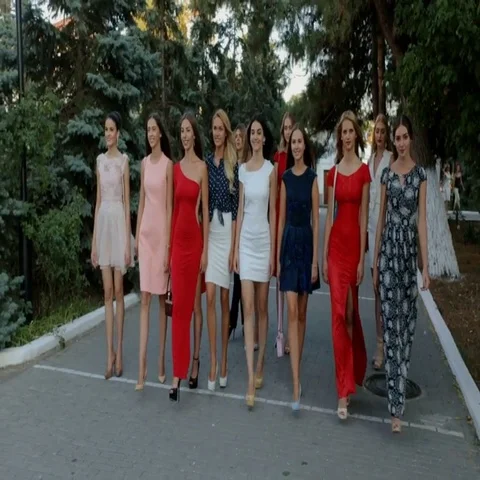 Group of attractive models in dresses walking down the street Stock Footage 69436623