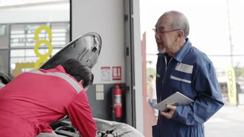 Group of auto mechanic Check condition car of factory. oil engine maintenance Stock Footage 156309008
