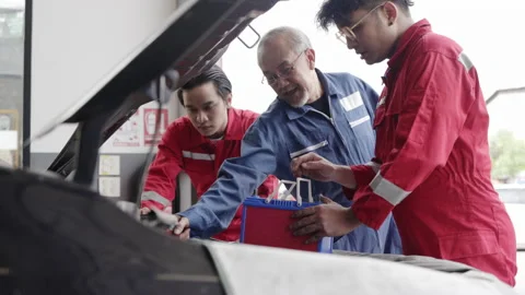Group of auto mechanic Check condition car of factory. oil engine maintenance Stock Footage 156309172